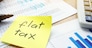 Memo with flat tax on an office table.