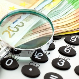 Euro Notes with calculator and magnifier. Closeup