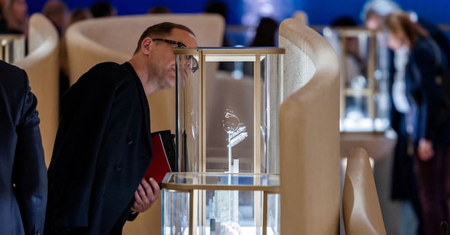 FILE PHOTO: A visitor looks at watch models at the Cartier booth at the Watches and Wonders exhibition in Geneva, Switzerland, April 9, 2024. REUTERS/Pierre Albouy/File Photo