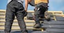 two carpenters working on the roof