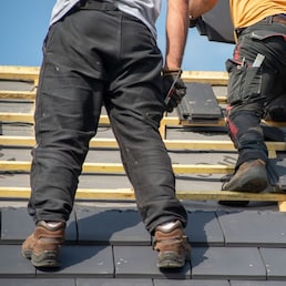 two carpenters working on the roof