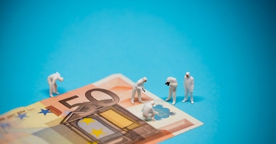 Specialists inspecting 50 euro banknote. Fraud concept. Macro photo
