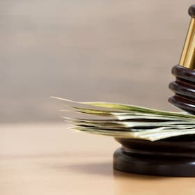 Law gavel on a stack of American money