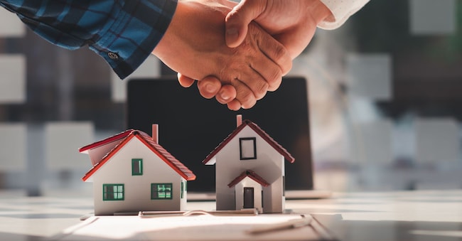 The real estate agent is explaining the house style to the clients who come to contact to see the house design and the purchase agreement, Mortgage loan approval home loan and insurance concept.