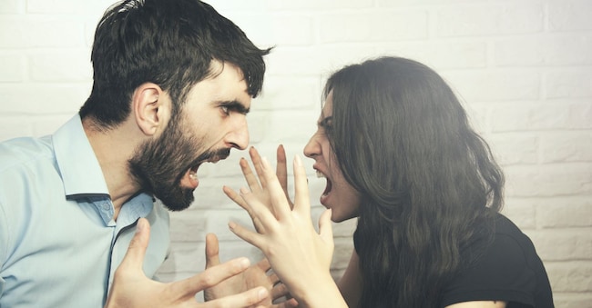 attractive angry couple fighting and shouting at each other