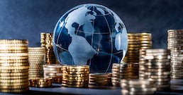 Globe and stack with coins. Money makes the world go round