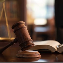 judge gavel, law books and scales of justice on desk in lawyer office.
legal justice concept.