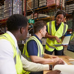 Team discussing warehouse logistics in an on-site office
