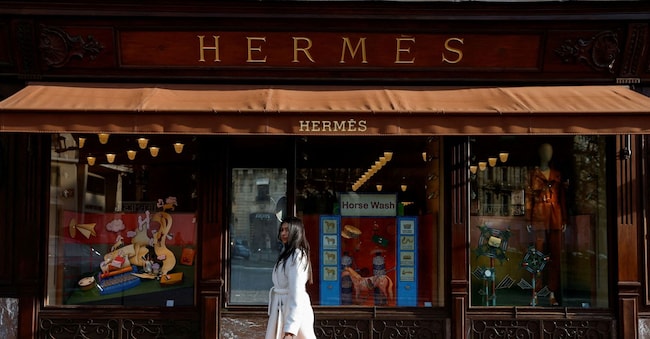 FILE PHOTO: A woman walks in front of a Hermes store in Paris, France February 14, 2025. REUTERS/Abdul Saboor/File Photo