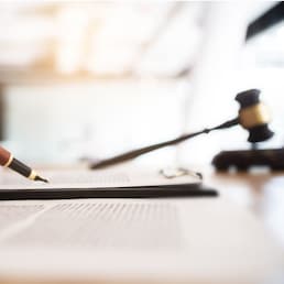 lawyer consultant with auction hammer at courtroom.