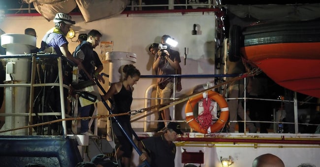 epa07682745 A handout photo made available by Sea-Watch shows Sea Watch 3 captain Carola Rackete (C) being arrested after entering the port of Lampedusa and ramming a patrol boat, in Lampedusa, Italy, 29 June 2019. According to reports, the captain Carola Rackete was arrested after violating orders from the Finance Police and entering the port of Lampedusa while ramming a patrol boat. EPA/SELENE MAGNOLIA/SEA-WATCH HANDOUT HANDOUT EDITORIAL USE ONLY/NO SALES