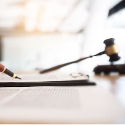 lawyer consultant with auction hammer at courtroom.