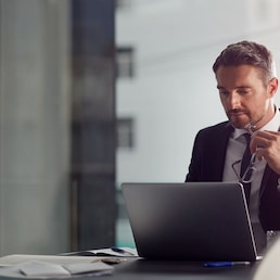 Laptop, thinking and boardroom with a businessman at work on research for future company growth. Computer, idea and innovation with a male employee or manager in his office with review his strategy.