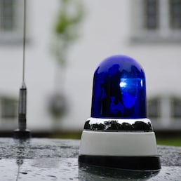 blue police light shining on an old police car in Denmark