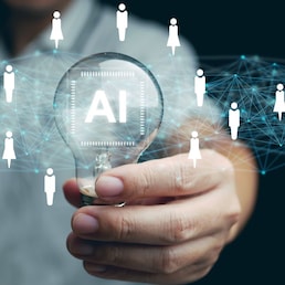 AI technology for HR, Human resources. A man holds lightbulb with artificial intelligence chip in it representing using Ai and automation to manage and recruit employees. Automate the hiring process