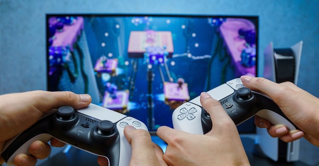 Sony PlayStation 5. New generation gaming computer. People playing video games. Couple play play with PS5. Point of view.