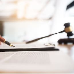 lawyer consultant with auction hammer at courtroom.