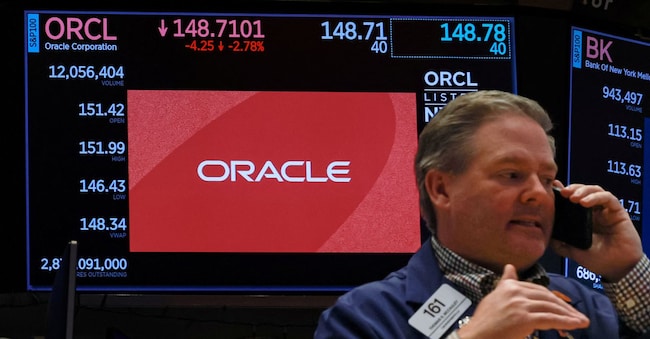 A trader works as a screen shows the logo and trading information for Oracle on the floor at the New York Stock Exchange (NYSE) in New York City, U.S., March 9, 2026.  REUTERS/Brendan McDermid