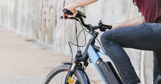 Close up man riding an e-bike