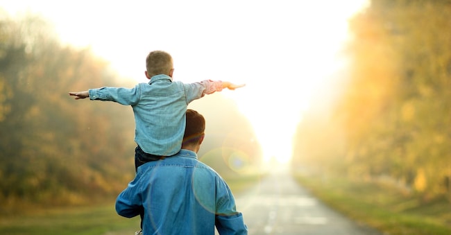 happy father and son walk in nature