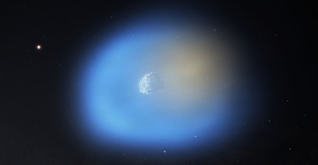 Rappresentazione artistica della cometa 3I/ATLAS Il metanolo nella coma è rappresentato in blu, il cianuro di idrogeno è rappresentato in arancione