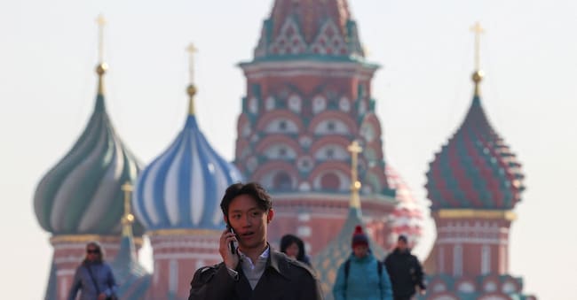 A man speaks on the phone while walking across Red Square near St. Basil's Cathedral in central Moscow, Russia, March 16, 2026. REUTERS/Anastasia Barashkova