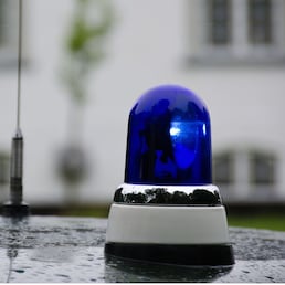 blue police light shining on an old police car in Denmark