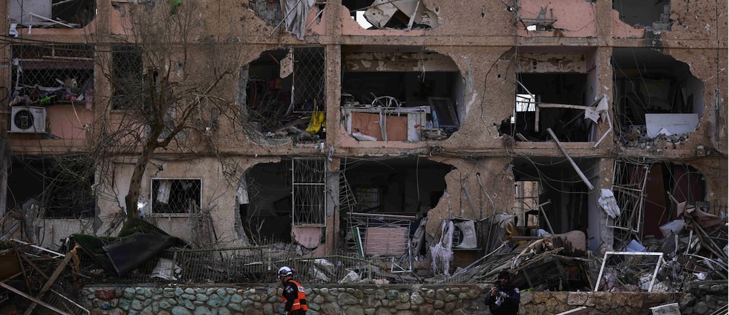 Le forze di sicurezza israeliane ispezionano il sito colpito da un missile iraniano a Dimona, nel sud di Israele, domenica 22 marzo 2026. (Foto AP/Ariel Schalit) APN