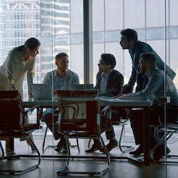 Corporate teamwork in the middle of a working day in a workplace meeting room AboutLife - stock.adobe.com