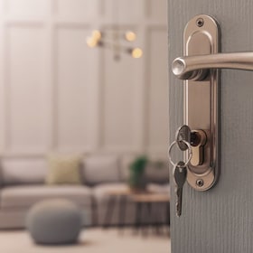 Closeup view of open door with key in room New Africa - stock.adobe.com