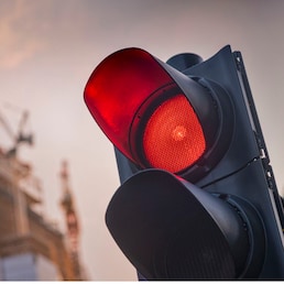Red traffic light with a construction site in the background Getty Images/iStockphoto