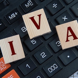IVA (Individual Voluntary Arrangement) - acronym on wooden cubes on the background of a calculator. Business concept Zhanna - stock.adobe.com