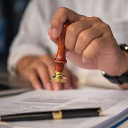 Contract law or paper work business and finance document rubber stamp. For official and legal contracts and agreements, financial statements, investment contracts, real estate documents. khunkornStudio - stock.adobe.com