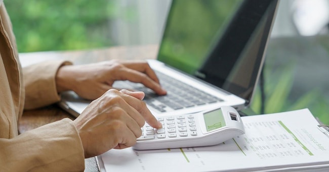 Calculating Cost Economic budget saving and investment concept analyzing investment charts and calculator Accounting