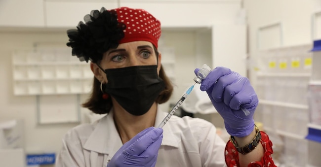 A senior nurse prepares a shot of the Pfizer-BioNTech COVID-19 vaccine  EPA