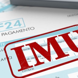 close up view of F24 form for italian taxes,the word imu and an electronic calculator (3d render) lucadp - stock.adobe.com