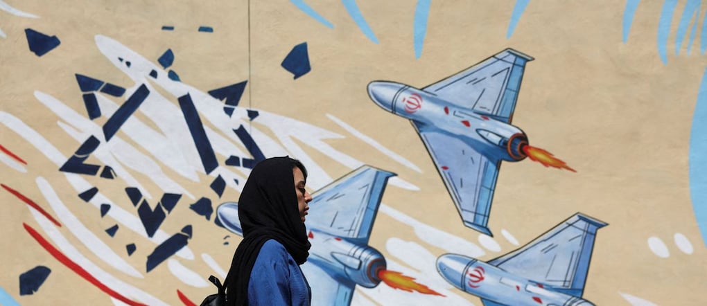 An Iranian woman walks next to an anti-Israeli mural on a street in Tehran, Iran, May 26, 2026. Majid Asgaripour/WANA (West Asia News Agency) via REUTERS ATTENTION EDITORS - THIS PICTURE WAS PROVIDED BY A THIRD PARTY via REUTERS