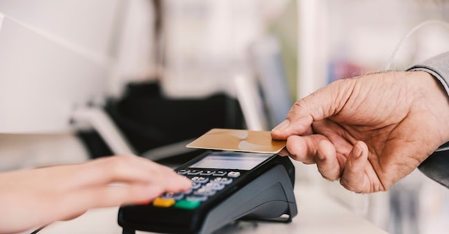 Close up of old man paying with credit card on pos terminal. Dusan Petkovic - stock.adobe.com