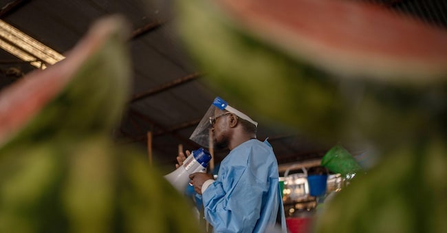epa13002634 A coordinator with U-Reporters, an UNICEF program to engage and inform local communities, wears a protective gown as he takes part in a campaign to raise awareness against Ebola in Goma, North Kivu, Democratic Republic of Congo, 29 May 2026. The World Health Organization (WHO) has declared that the Ebola disease caused by the Bundibugyo virus in the Democratic Republic of the Congo and Uganda constitutes a public health emergency of international concern (PHEIC).  EPA/MARIE JEANNE MUNYERENKANA EPA