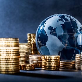 Globe and stack with coins. Money makes the world go round gopixa - stock.adobe.com