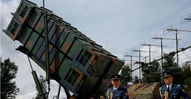 Alcuni membri della Guardia d'Onore camminano accanto a un lanciatore del sistema di difesa aerea Patriot dopo aver celebrato la Giornata delle Forze Aeree ucraine, nel contesto dell'attacco russo all'Ucraina, in una località non specificata, Ucraina, 4 agosto 2024. REUTERS/Valentyn Ogirenko/Foto d'archivio REUTERS