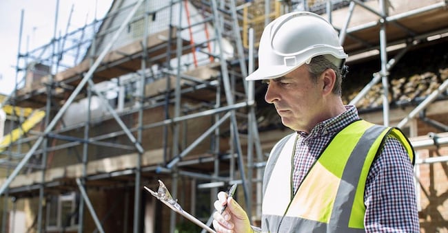 Building Inspector Looking At House Renovation Project