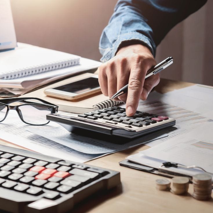 businessman working in office with using a calculator to calculate the numbers finance accounting concept lovelyday12 - stock.adobe.com
