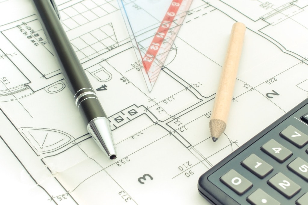 Drawing accessories and calculator on electrical construction drawing of house, building home cost concept