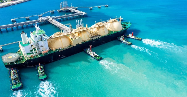 LNG (Liquefied natural gas) tanker anchored in Gas terminal gas tanks for storage. Oil Crude Gas Tanker Ship. LPG at Tanker Bay Petroleum Chemical or Methane freighter export import transportation