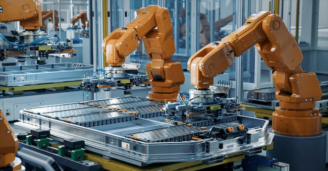 Orange Industrial Robot Arms Assemble EV Battery Pack on Automated Production Line. Row of Advanced Robotic Arms inside Automotive Plant Assemble Batteries. Modern Electric Car Smart Factory. IM Imagery - stock.adobe.com