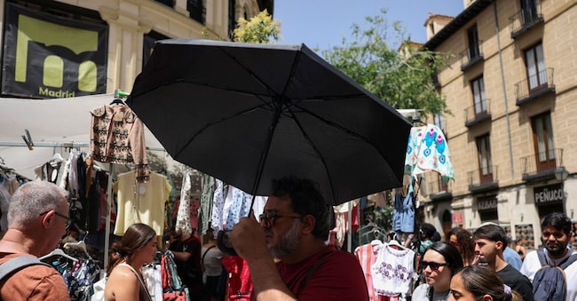 Turisti e residenti fanno acquisti al mercatino delle pulci El Rastro durante una calda giornata estiva nel centro di Madrid, in Spagna, il 21 giugno 2026.  REUTERS/Mohammed Salem REUTERS