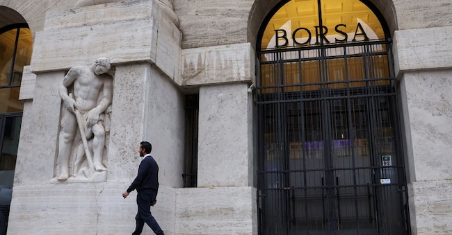 FILE PHOTO: A man walks past the Milan stock exchange building, in Milan, Italy November 27, 2023. REUTERS/Claudia Greco/File Photo REUTERS