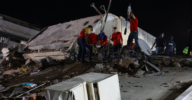 Rescue workers search through the rubble of a collapsed building after an earthquake in Caracas, Venezuela, Wednesday, June 24, 2026.(AP Photo/Javier Campos) APN