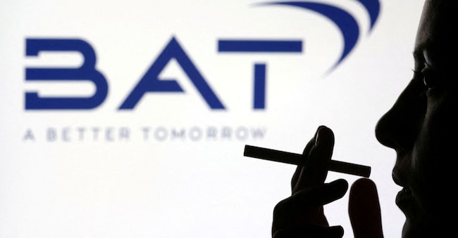 FILE PHOTO: A woman poses with a cigarette in front of BAT (British American Tobacco) logo in this illustration taken July 26, 2022. REUTERS/Dado Ruvic/Illustration/File Photo REUTERS